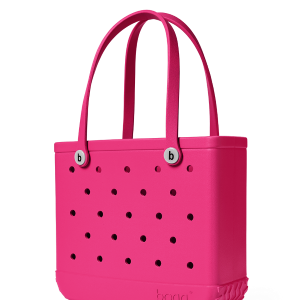 Pink tote bag with black polka dots on a white background