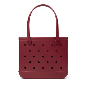 Maroon handbag with black polka dots on a white background