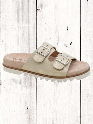 An image featuring a pair of black Corkys Dash sandals with adjustable buckles and a flat sole, displayed against a wooden background.