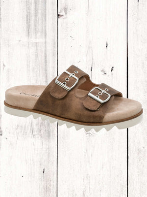 An image featuring a pair of black Corkys Dash sandals with adjustable buckles and a flat sole, displayed against a wooden background.
