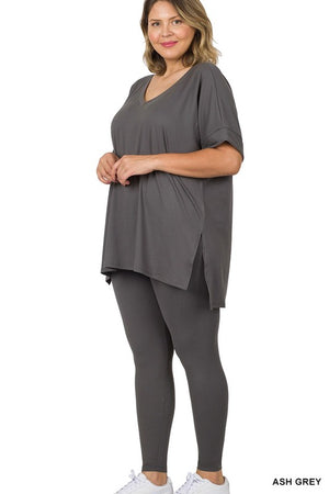Woman wearing an ash grey outfit on a white background