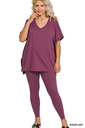 Woman wearing an eggplant-colored outfit on a white background