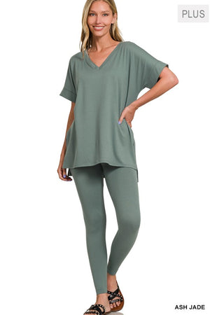 Woman wearing a green outfit with a plain background