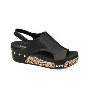 Black sandal with decorative sole on a white background