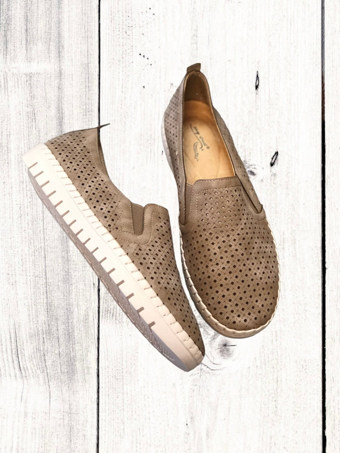 A pair of black Easy Street brand sneakers with a flexible outsole, featuring a perfed upper with twin gores for stretch fit, and an insole with a light-colored footbed.