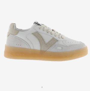 White sneaker with beige accents on a white background