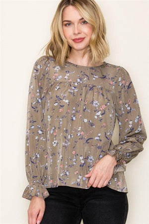 Woman wearing a floral blouse with a plain background