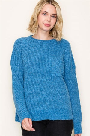 Woman wearing a blue sweater against a white background