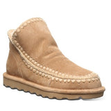 Tan suede ankle boot with braided detail on a white background