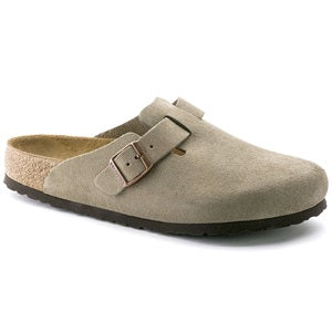 Beige clog shoe with a strap on a white background