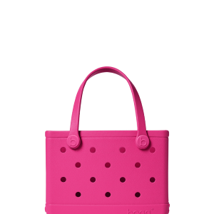 Pink handbag with black polka dots on a white background