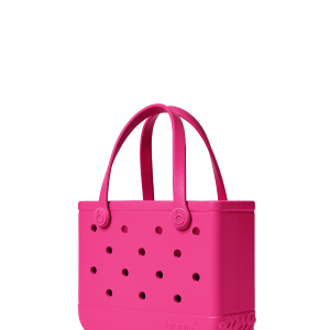 Pink handbag with black polka dots on a white background