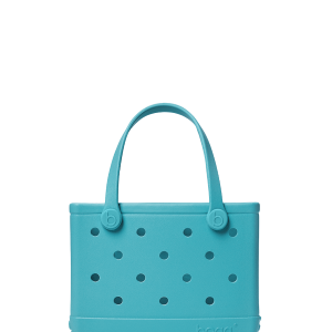 Turquoise handbag with polka dot pattern on a white background