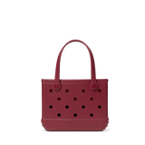 Maroon handbag with polka dot pattern on a white background