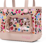 Multicolored patterned bag with 'bogg' branding on a beige background