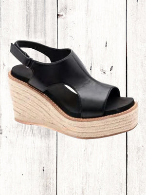 A white faux leather wedge sandal with a floral pattern on the platform and a braided wedge heel.