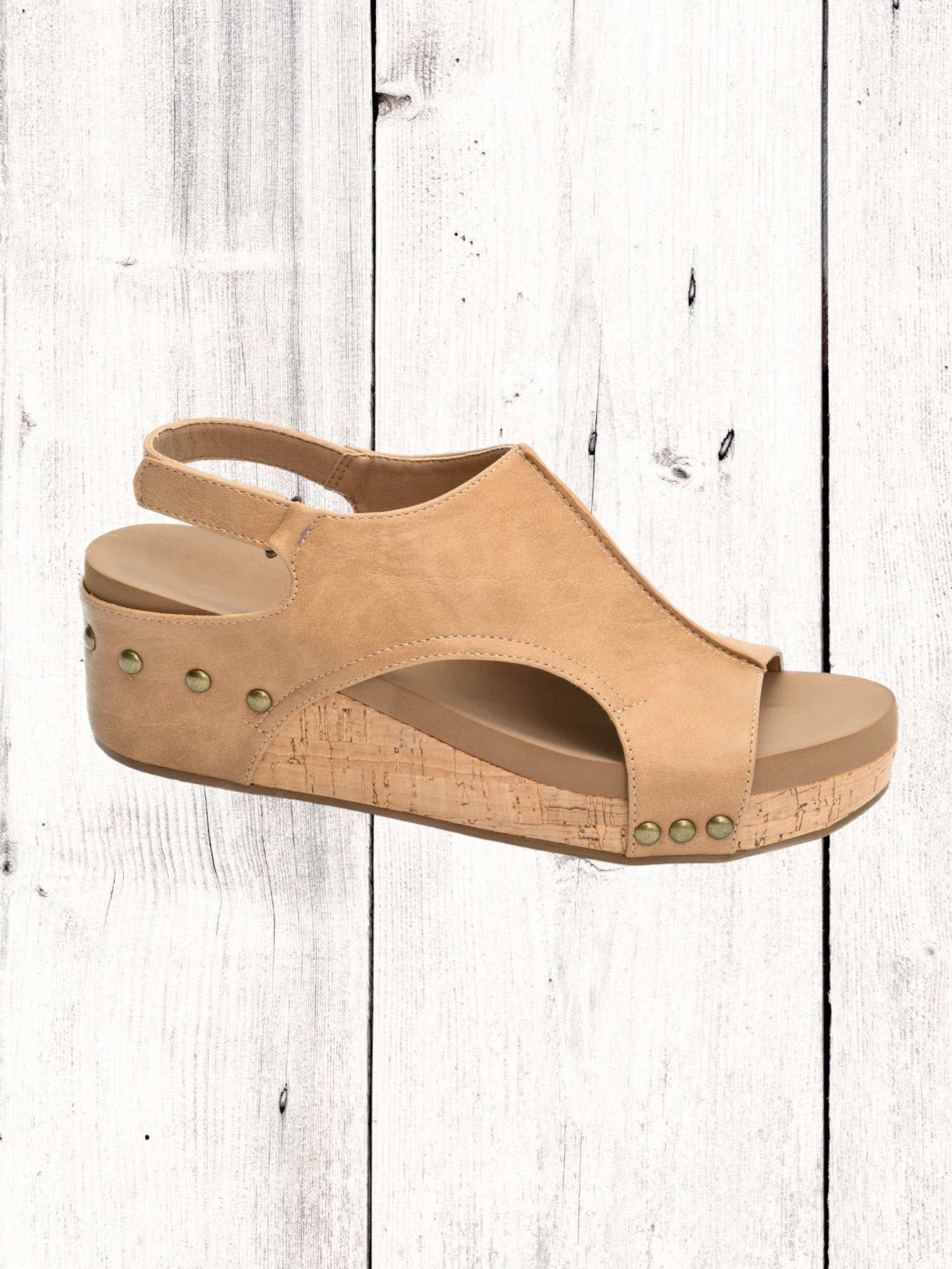 A black Corkys Volta II wedge sandal with a faux leather upper and cork wedge heel, featuring a hook and loop closure and studs on the heel.