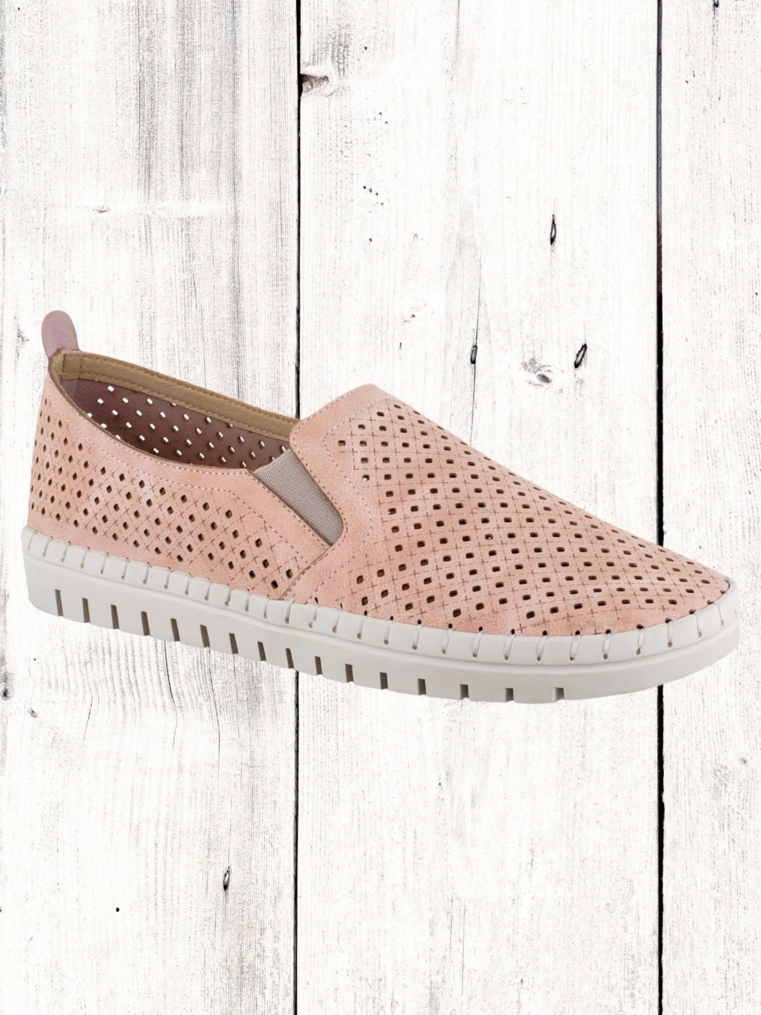 A navy perforated sneaker with a lightweight white sole, featuring twin gores for fit.