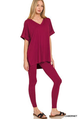 Woman wearing a cabernet-colored outfit on a white background