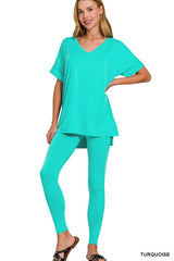 Woman wearing a turquoise outfit on a white background