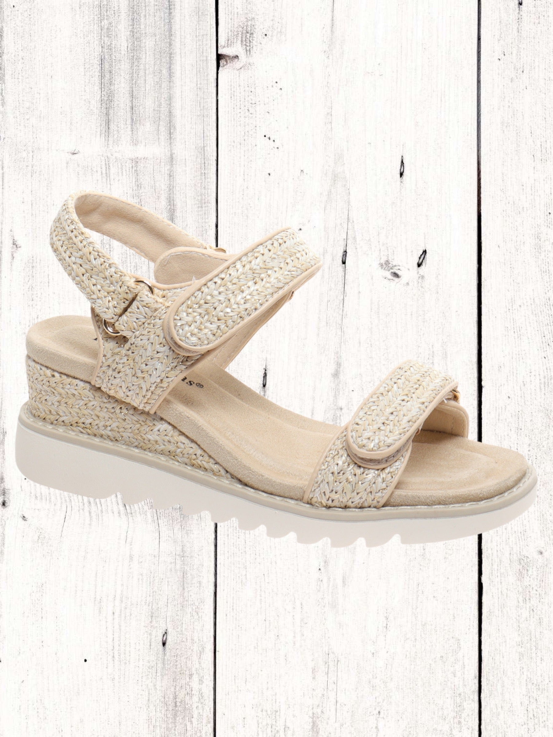 A black and white geometric patterned wedge sandal with two Velcro straps and a cushioned insole.