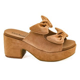 Tan suede platform sandal with knot detail on a white background