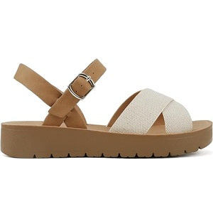 Tan sandal with white criss-cross strap on a white background