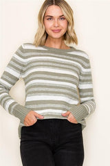 Woman wearing a striped sweater with a plain background