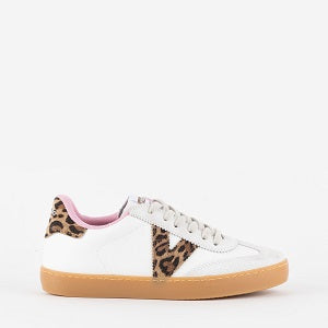 White sneaker with leopard print accents on a white background