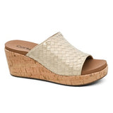 Gold wedge sandal with cork sole on a white background